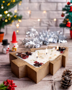 Eco-friendly soy wax candle shaped like a Christmas tree, featuring holiday decor and warm lighting.